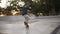 Young active skater making flip trick and turning longboard while riding in skate park alone. Slow motion