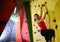 Young Active Woman Bouldering on Colorful Artificial Rock in Climbing Gym. Extreme Sport and Indoor Climbing Concept