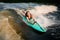 Young active woman lying on the wakesurf holding rope of motorboat