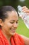 Young active woman refreshing water in face