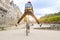 Young active woman riding a bicycle going down the road in the city