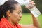 Young active woman splashing water in face