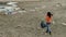 Young activist cleaning destroyed beach