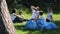 Young activist family recycle plastic bottle talking and sitting at green park during cleanup on summer day spbi.