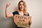 Young activist woman asking for environment holding banner with protect planet message screaming proud and celebrating victory and