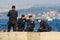 Young adult attractive smiling turkish police officers in stylish police uniform have a rest on the Bosphorus background.