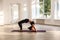 Young adult attractive yogi woman practicing yoga, stretching in elbow bridge exercise, dvi pada viparita dandasana pose, working