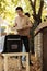 Young adult with backpack delivering organic produce in box