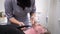 Young adult beautiful caucasian woman hairdresser cuts beard handsome man at beauty saloon