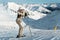 Young adult beautiful happy attr Ñactive caucasian smiling skier woman full lenght body portrait mountain peak showing