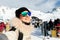 Young adult beautiful happy attractive caucasian smiling hiker woman portrait making selfie on mountain peak showing skiing resort