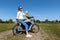 Young adult beautiful mother and daughter enjoy having fun riding electric scooter bike or rural countryside dirt road