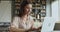 Young adult business woman typing on laptop sit at table