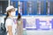 Young adult female wearing face mask in airport terminal, protection Coronavirus disease infection, Asian woman traveler with hat