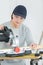 Young adult female woodworker cutting board in workshop