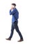 Young adult formal dressed man talk on the phone walking and looking away. Side view