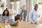 Young adult friends having coffee at home, looking to camera