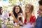 Young adult friends socialising at a table in a garden