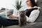 Young Adult Girl Working at Laptop from Home and Plays with Her Little Scottish Fold Cat, Concept of Remote Work, Freelance