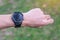 Young adult male checking time and cardio heart rate on sport smartwatch during running in the park outdoor, runner man jogging on