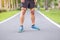 Young adult male in sport shoes ready to running in the park outdoor, runner man jogging and walking on the road at morning, leg