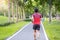 Young adult male in sportswear running in the park outdoor, runner man jogging on the road, asian Athlete walking and exercise in