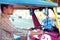 Young adult man drives traditional asian transport tuk-tuk