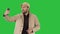 Young adult man handsome taking selfie on a Green Screen, Chroma Key.