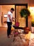 Young adult man preparing food for family on evening patio at home