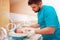 Young adult man taking care of newborn baby in infant incubator