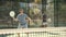 Young and adult men playing padel tennis on court