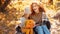 Young adult mother and daughter looking at carved pumpkin with smoke