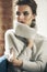 Young adult sensuality brunette woman in gray sweater