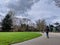 Young adult skateboarding down a walking path on a popular day at the Wilmot Gateway Riverfront Park in Woodinville