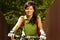 Young adult smiling biker woman on mounting bike