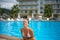 Young adult smiling woman in outdoor waterpool