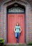 Young Adult Standing in front of Door