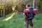 Young adult traveler walking in a forest