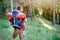 Young adult traveler walking in a forest for a trip