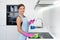 Young adult woman cleaning electric stove in kitchen