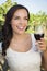 Young Adult Woman Enjoying A Glass of Wine in Vineyard