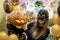 Young adult woman hold in hand spooky custom weird handmade orange pumpkin head with carved faces and glowing candle or
