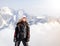 Young adult woman snowboarder holding snow board