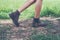 Young adventure woman feet walking on gravel in the forest.