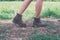 Young adventure woman feet walking on gravel in the park.