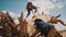 Young adventurer, woman tourist climbing on the tree trunk in the desert. Focus on the backpack in foreground