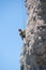 Young adventurous person rock climbing