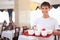 Young affable waiter keeps tray at restauran