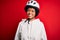 Young African American afro cyciling woman with curly hair wearing bike security helmet with a happy and cool smile on face