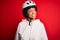 Young African American afro cyciling woman with curly hair wearing bike security helmet looking away to side with smile on face,